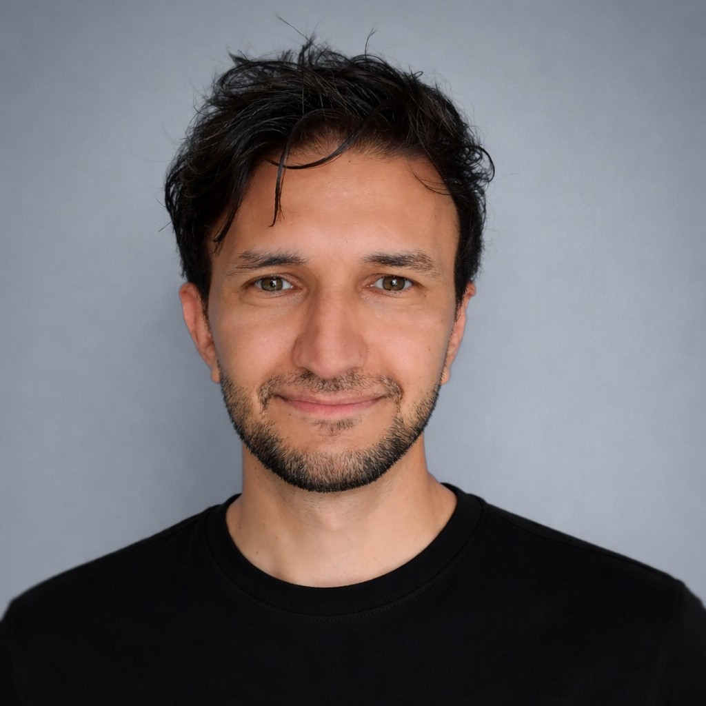Mohamadjavad Shoori, photographed against a plain grey wall.